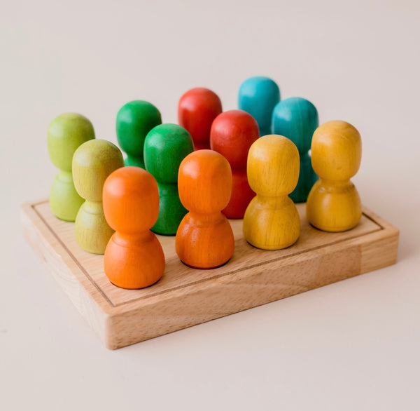 Large wooden people on tray