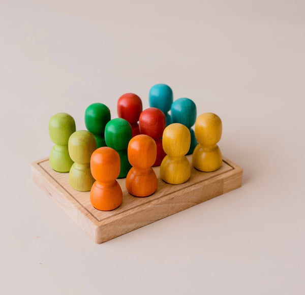 Large wooden people on tray